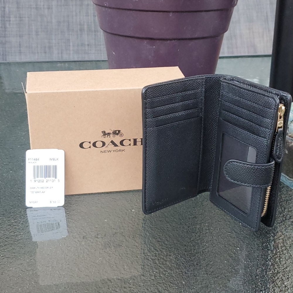Black leather Coach™️ folding wallet